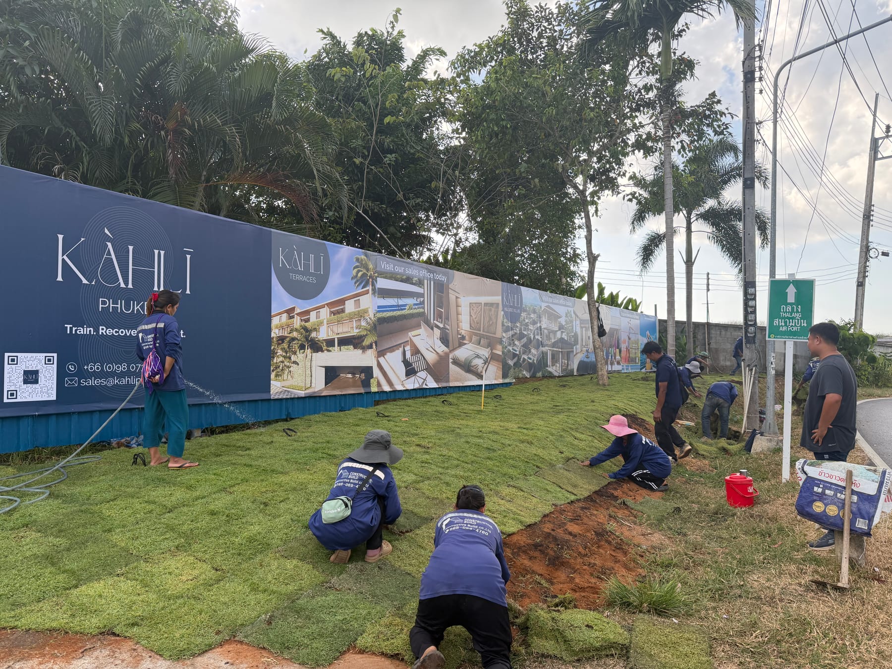 C:B crew preparing turf in front of the KAHLI Phuket hoarding