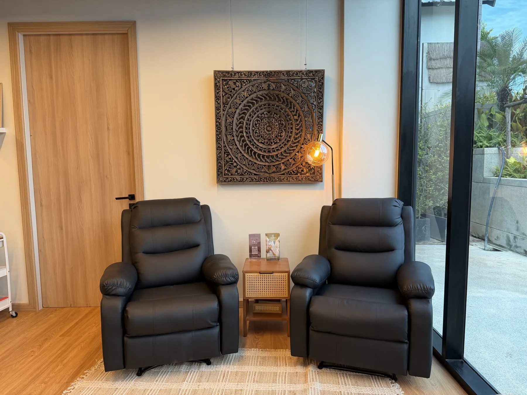 Live More Clinic: waiting lounge with recliners, mandala wall art and warm pendant light