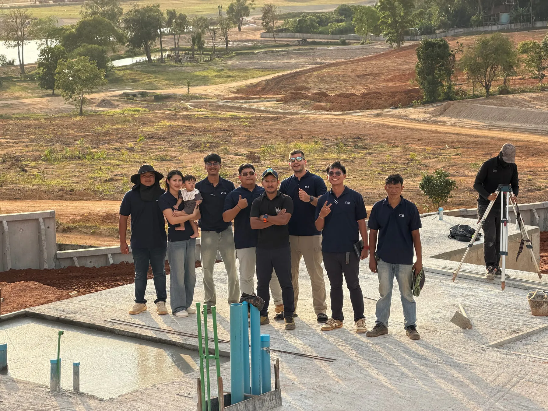 The Constructive: Build team on site at KAHLI Phuket: eight principals in C:B-branded uniforms with the surveyor at right