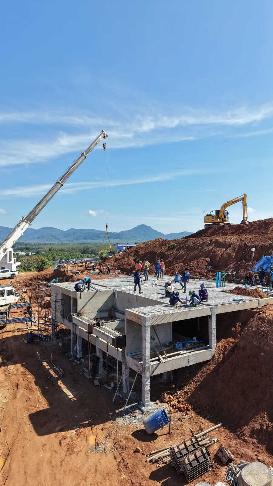 Precast technology: a structural precast panel being craned into position on an active residential build