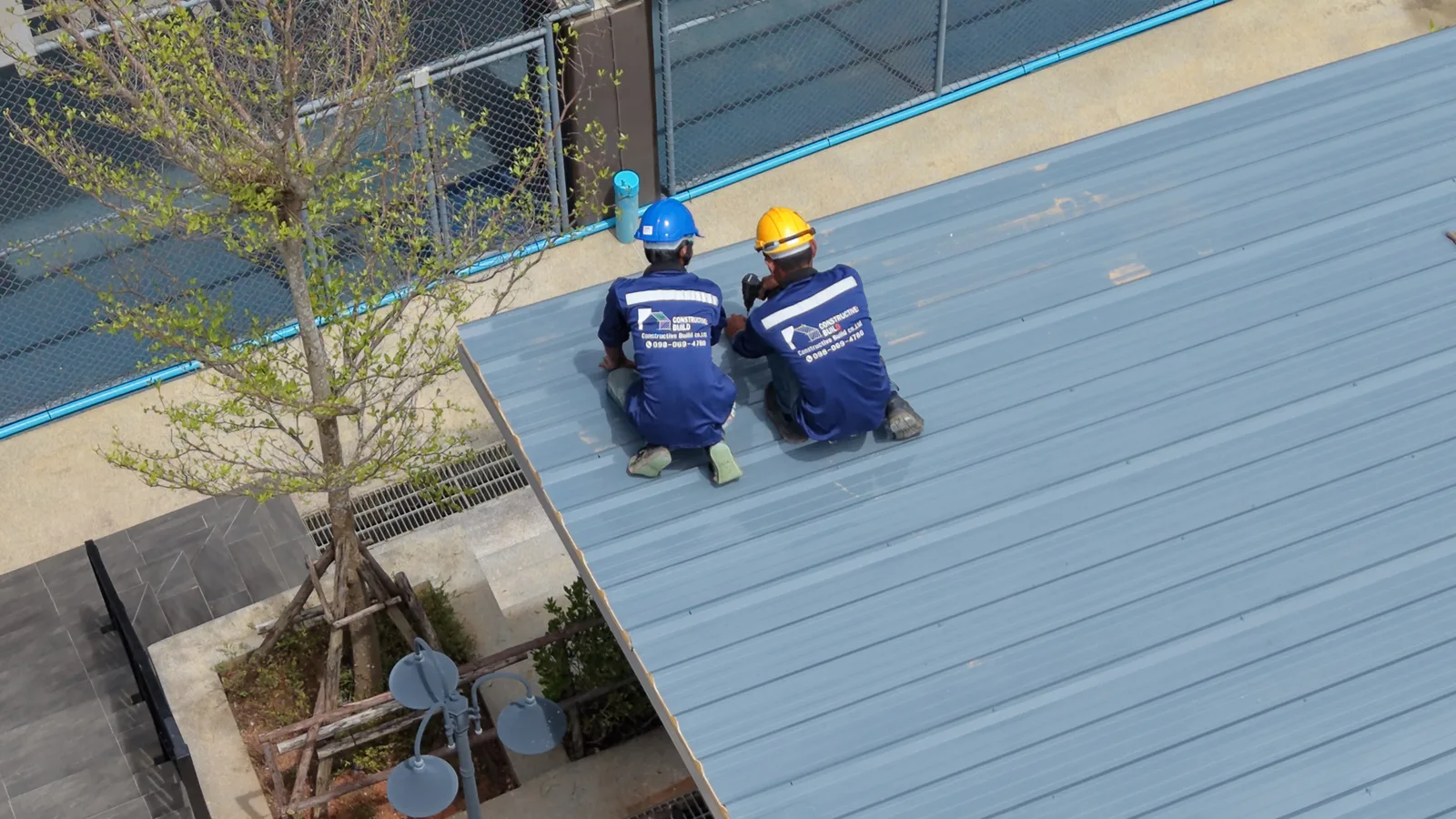 Construction and main contracting: Constructive: Build in-house trades in branded uniforms working on a roof installation